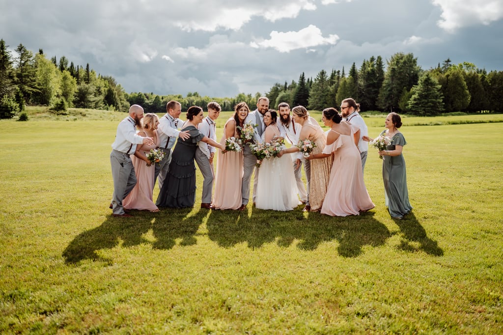 bridal party running towards bride and groom