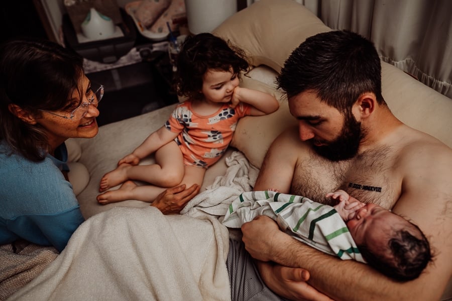 Woman giving birth at home