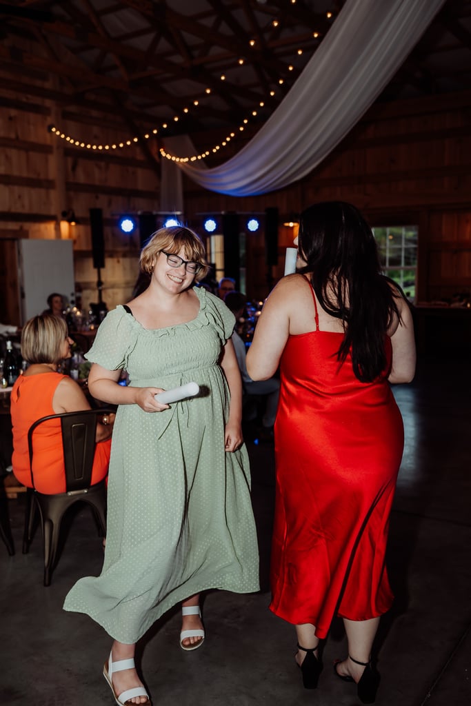 wedding guests dancing at a reception wearing a red and green dress