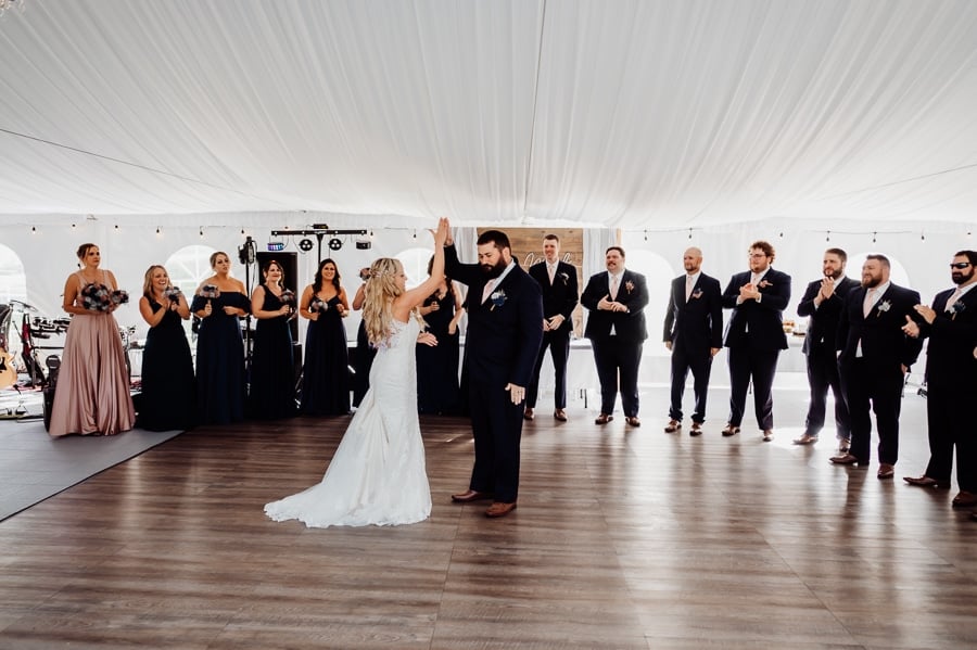 bride and groom giving high five at wedding reception