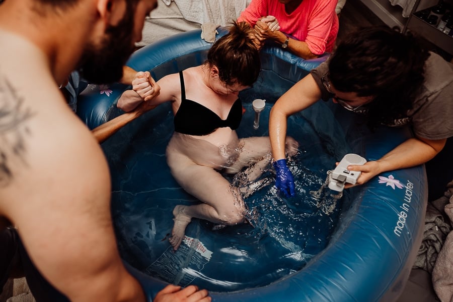 Mother giving birth at home
