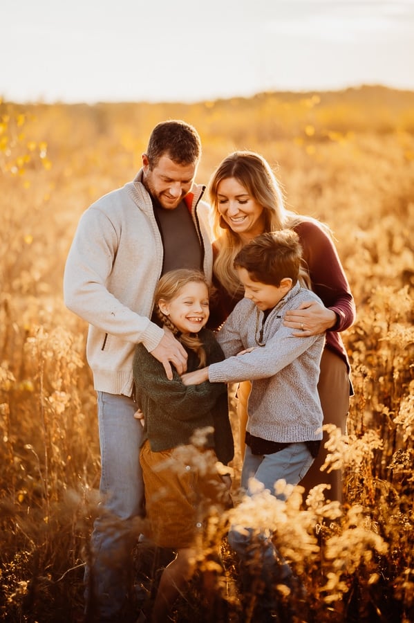 Family of four laughing together