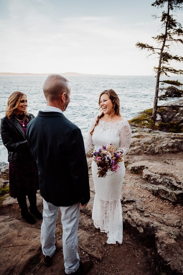 Bride laughing with groom during elopement ceremony at Schoodic overlook
