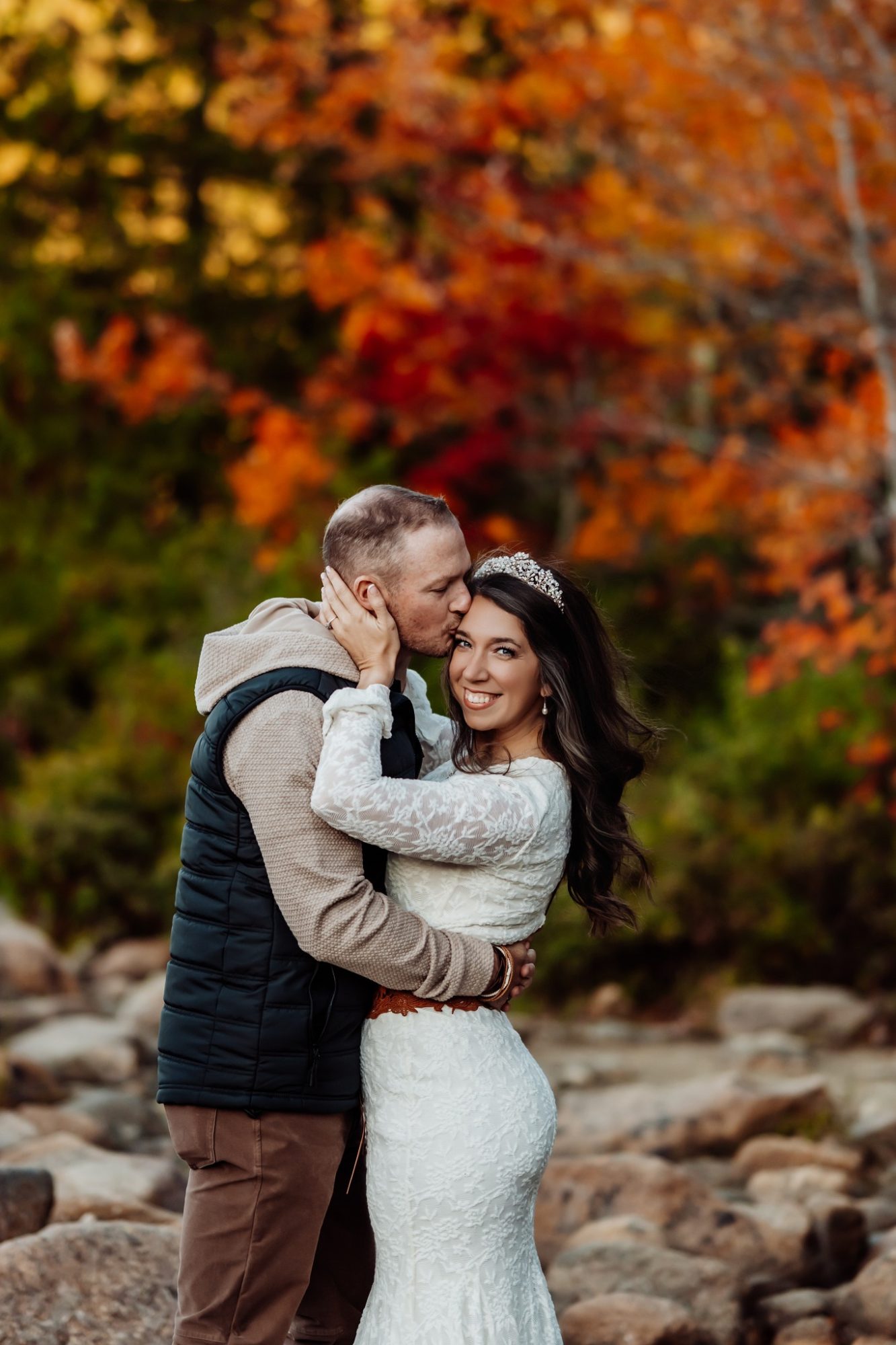 close-up portrait with fiery autumn leaves during Acadia fall elopement.