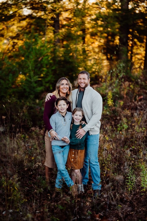 Family of four in the woods posing together