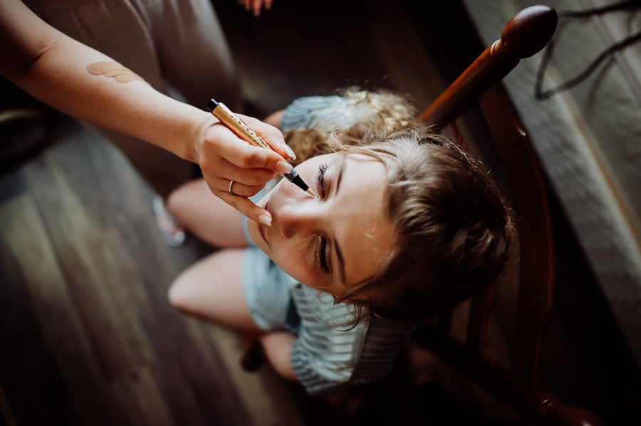 Girl getting makeup done by artist