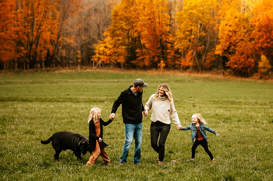 Fall family photos against orange trees