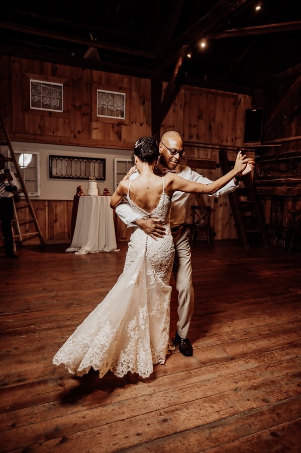 Bride and father dancing together at wedding in Maine barn