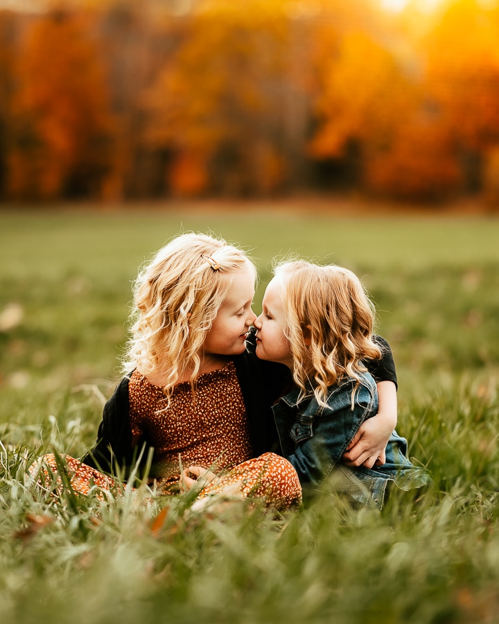Little girls looking at each other in the fall