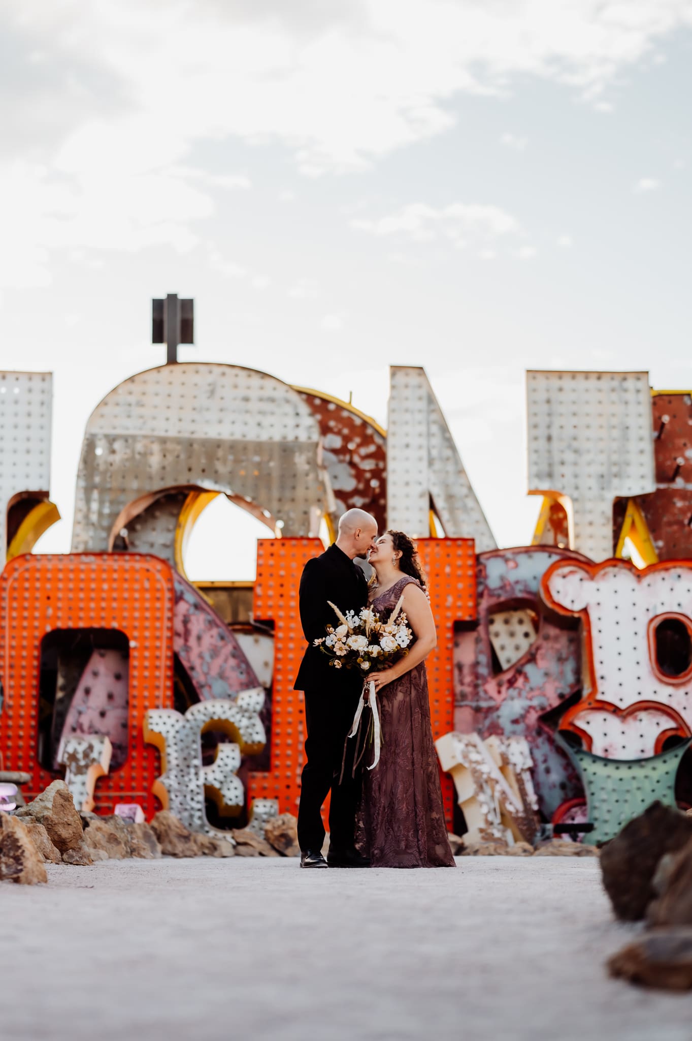 Couple standing at neon sign museum