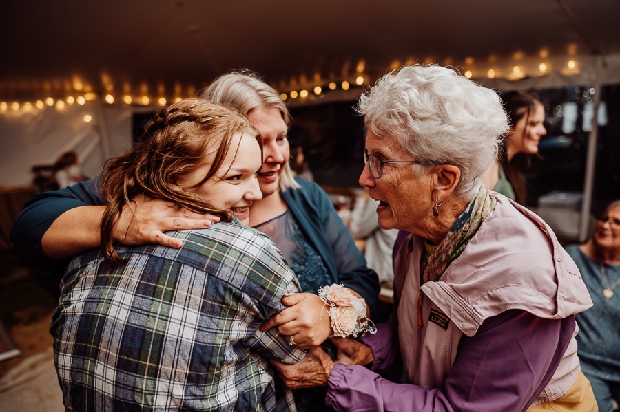 People hugging and smiling together at wedding reception