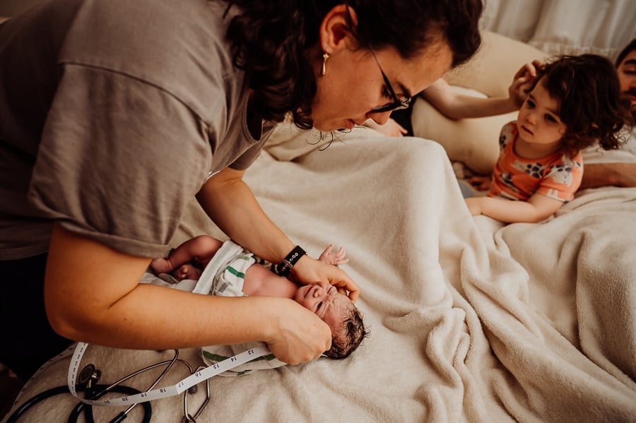 Woman giving birth at home