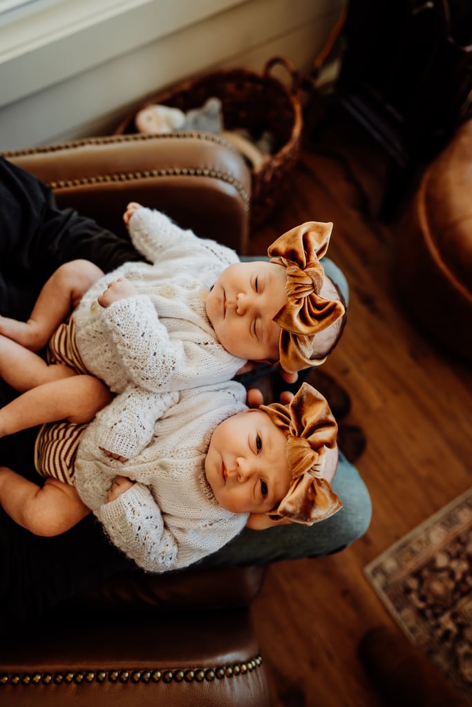 Twin newborn girls posing in home