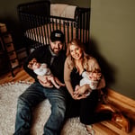 Twin newborn girls posing in home