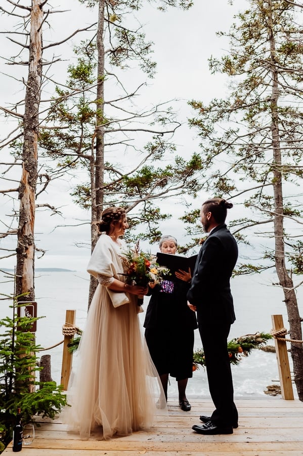 bride and groom saying vows in machiasport next to ocean edge