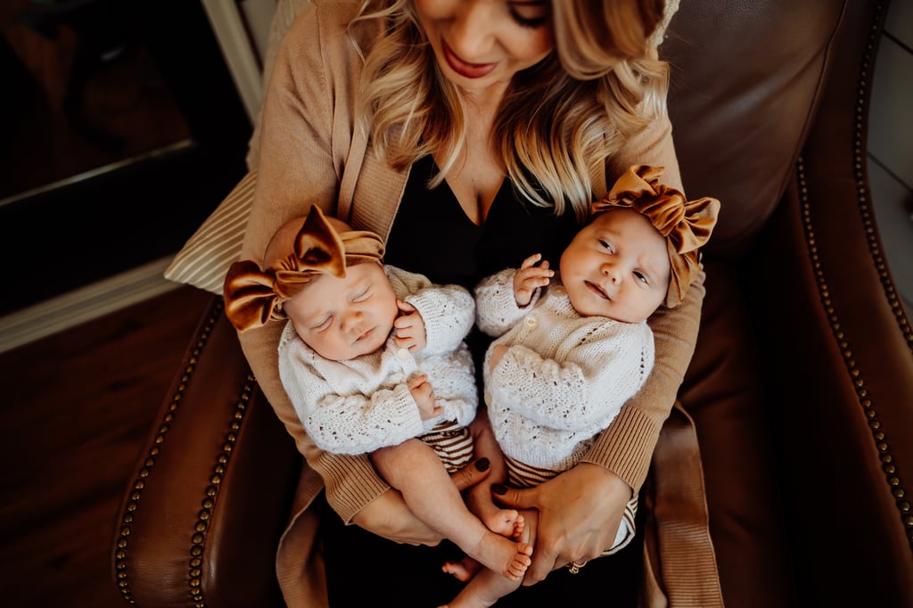 Twin newborn girls posing in home
