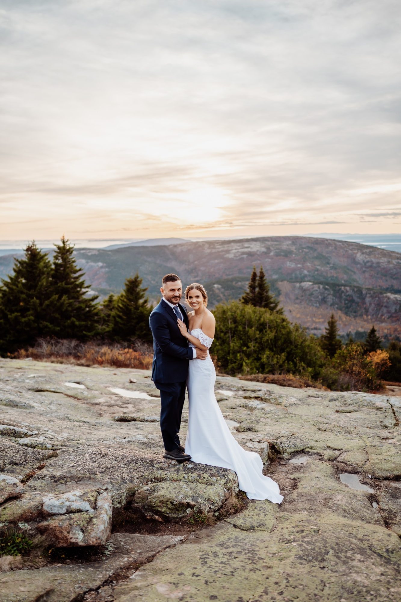 Couple standing together on rocky terrain during their Schooner Head elopement in Acadia National Park.