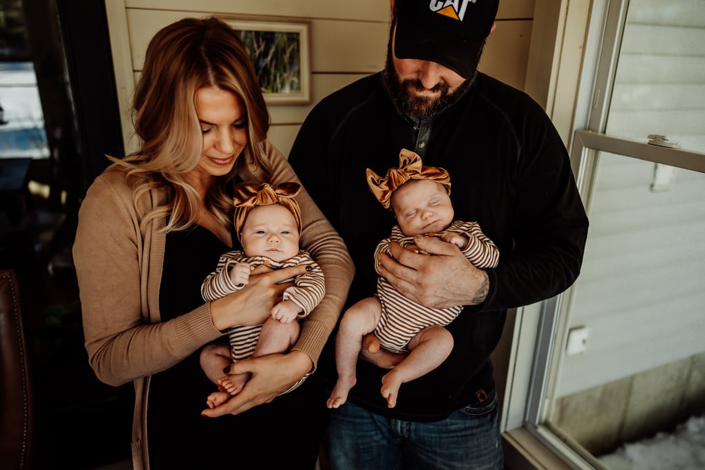 Twin newborn girls posing in home