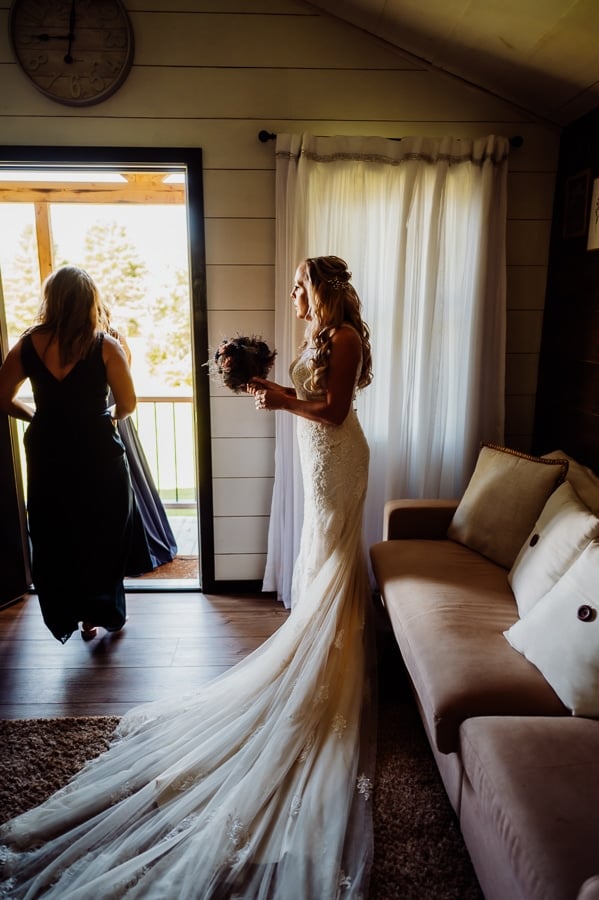 Bride in wedding dress in cabin before walking down isle