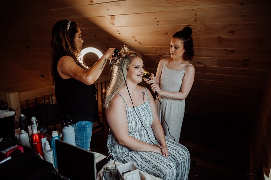 Bride getting hair done before wedding