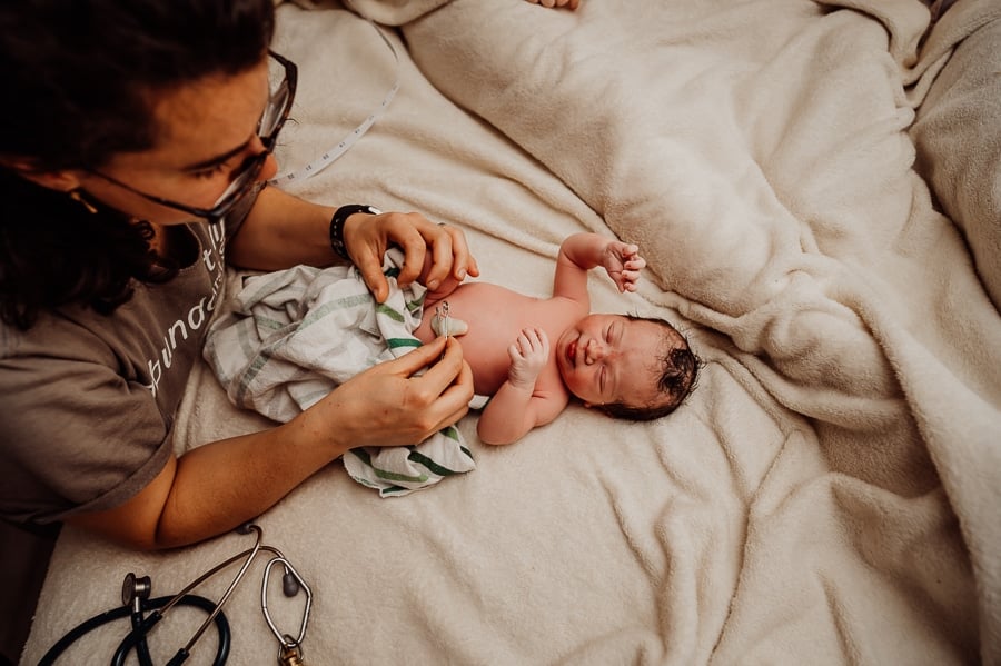 Woman giving birth at home
