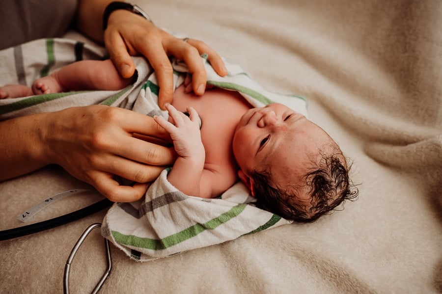 Woman giving birth at home