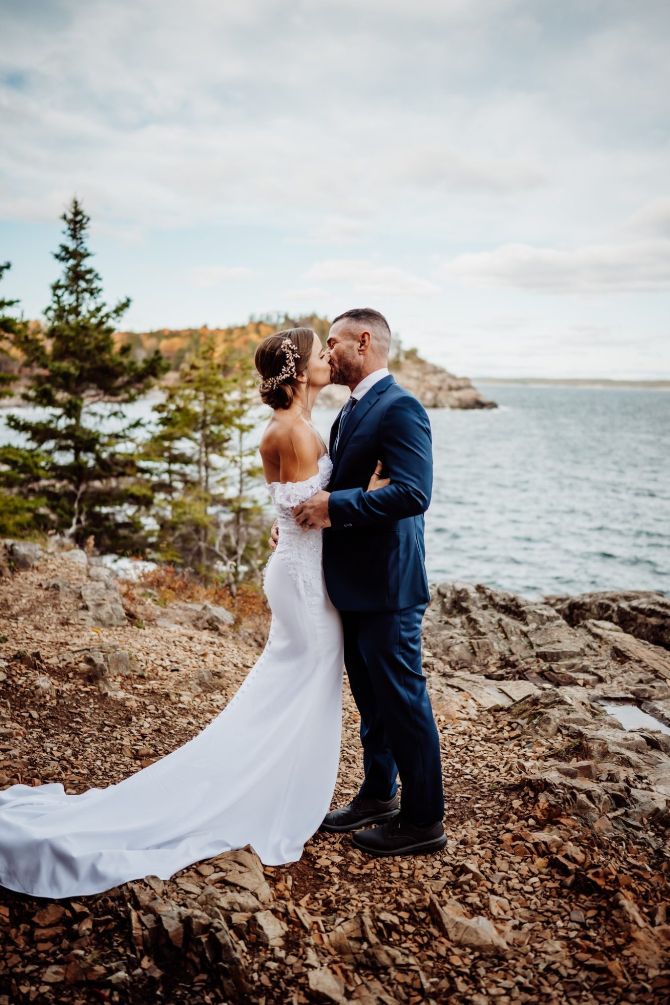 Sunset elopement kiss overlooking the ocean at Schooner Head Overlook in Acadia National Park.