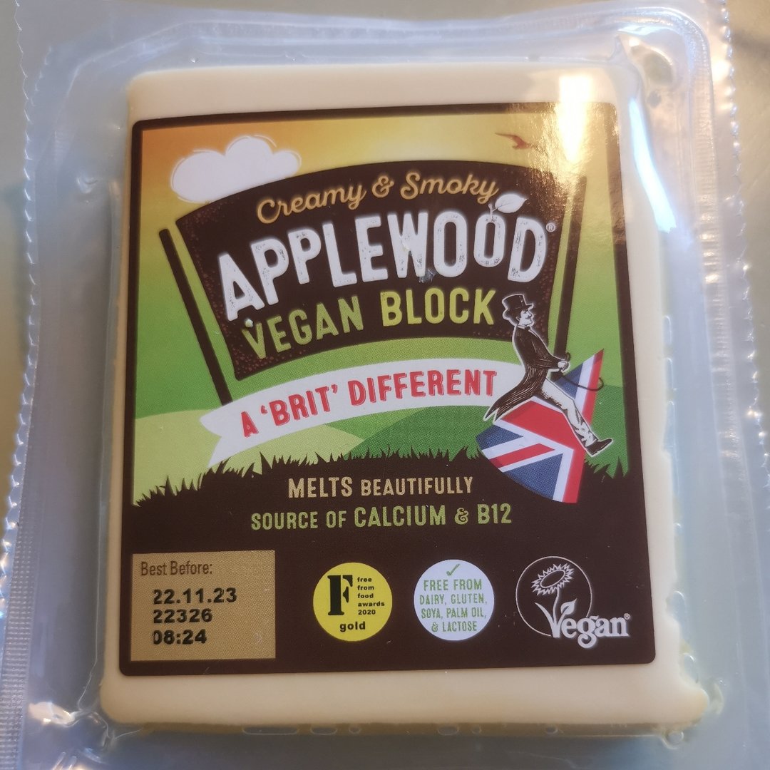 A block of yellowish vegan cheese in a plastic wrapper. The brand, Applewood, is written on top and the slogan "A Brit different" is below. 