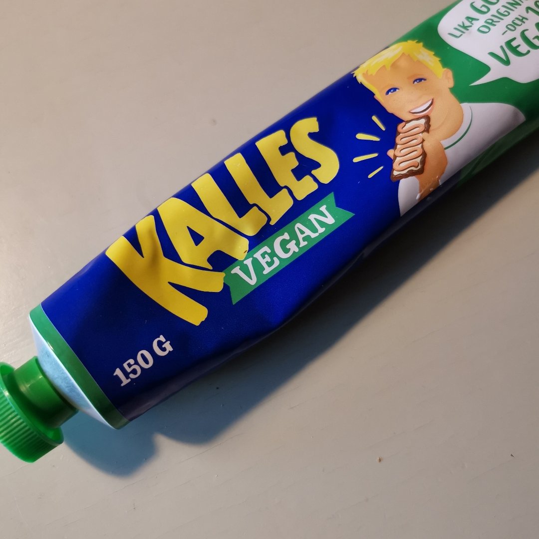 A bue tube of Kalles vegan caviar. The tube has a picture of a boy eating a sandwich with Kalles caviar on it.