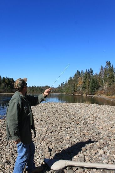 An angler hard at work steelhead fishing near the Algoma Motel in Wawa Ontario Canada
