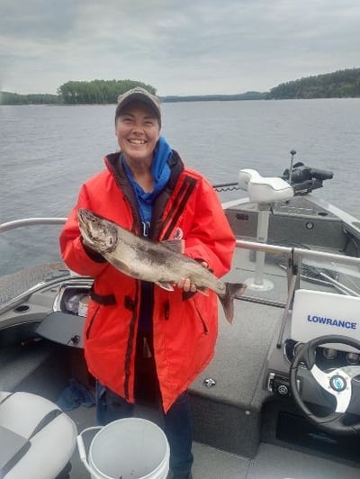 A happy customer with her Lake trout catch near the Ontario town of Wawa and the Algoma Motel