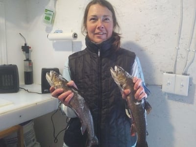 Sammy showing off her catch of the day lake trout at one of the mini lakes close to the Algoma Motel in Wawa Ontario Canada
