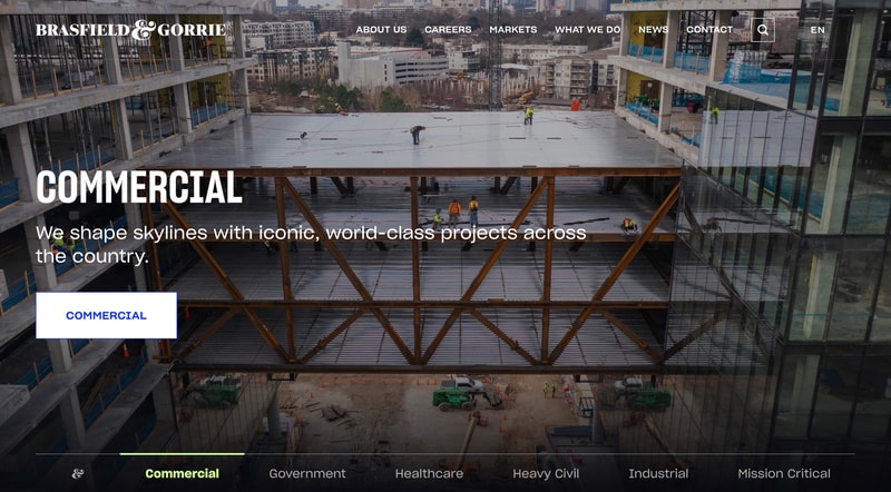 Brasfield & Gorrie homepage hero showing workers on a commercial construction site with the headline "COMMERCIAL: We shape skylines with iconic, world-class projects across the country" and a market-segmented tabbed navigation underneath