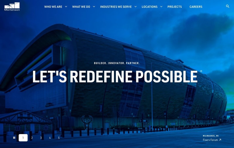 Mortenson homepage hero showing Fiserv Forum in Milwaukee at dusk with the headline "Let's Redefine Possible," a numbered one-to-five project selector at the bottom left, and a navigation bar whose third item is Industries We Serve
