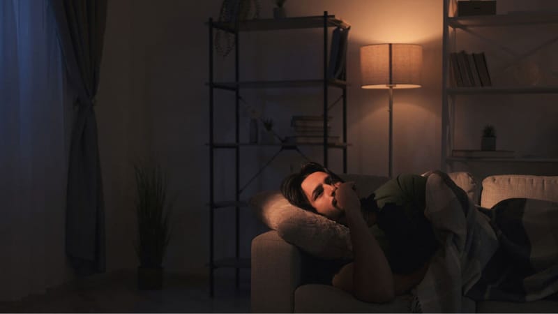A person laying down in the dark