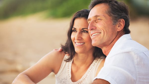 Mature couple enjoying sunset on the beach