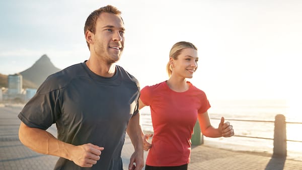 Two people running on the road