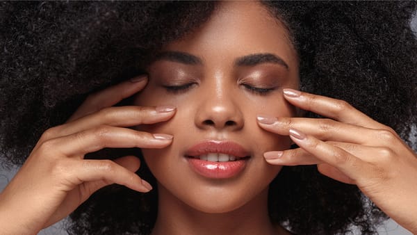 A person holding her hands on her face