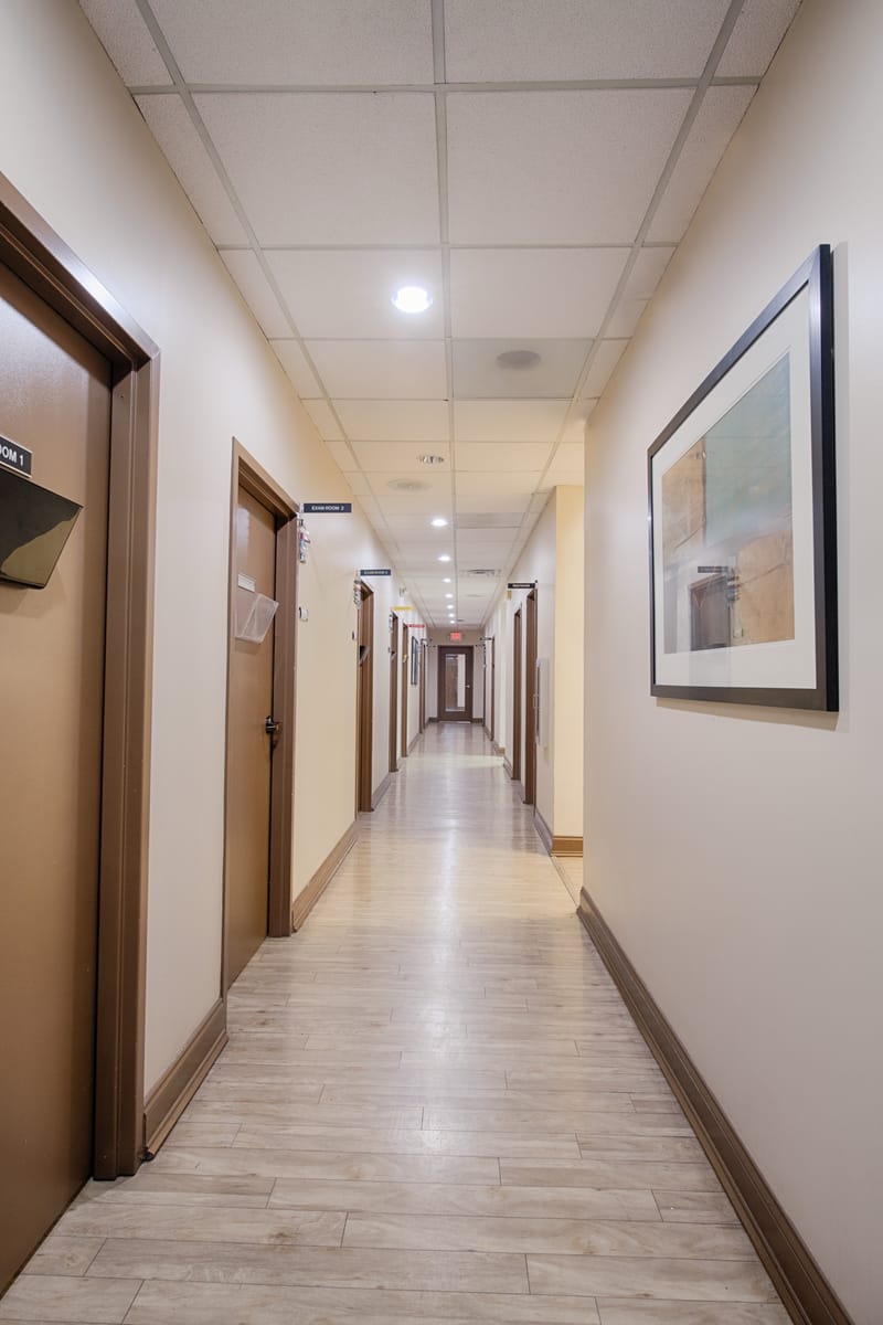 A hallway connecting exam rooms inside Progressive Medical Center's Atlanta facility