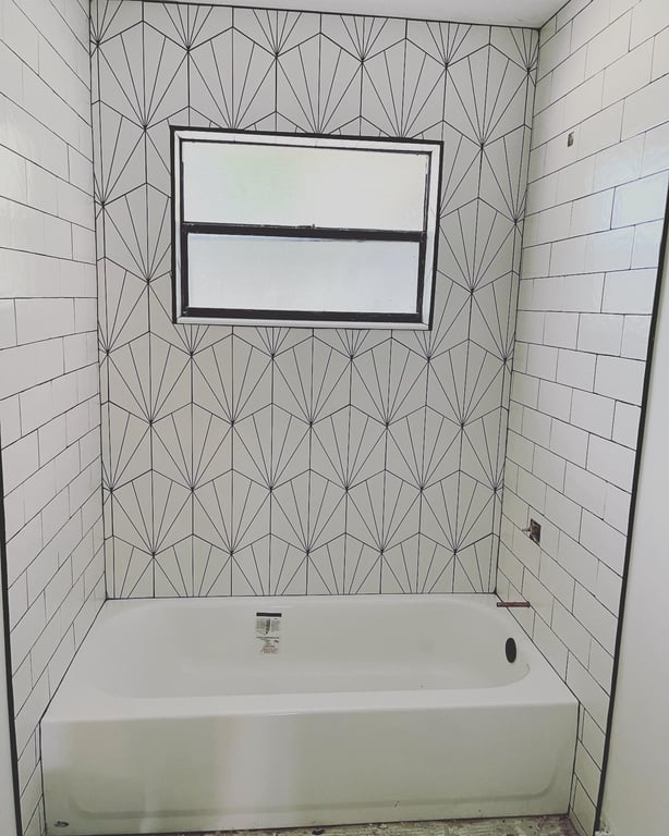 Tile work done on bathroom wall