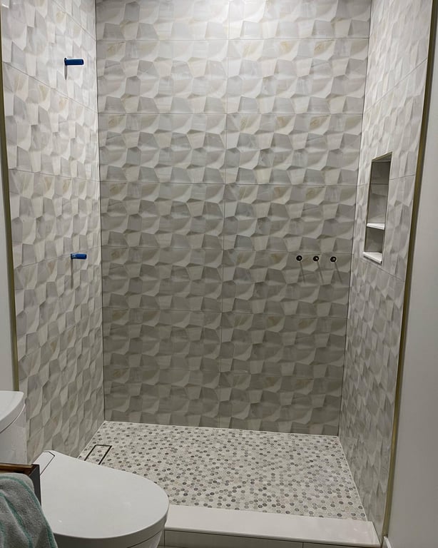 Tile work done on bathroom wall