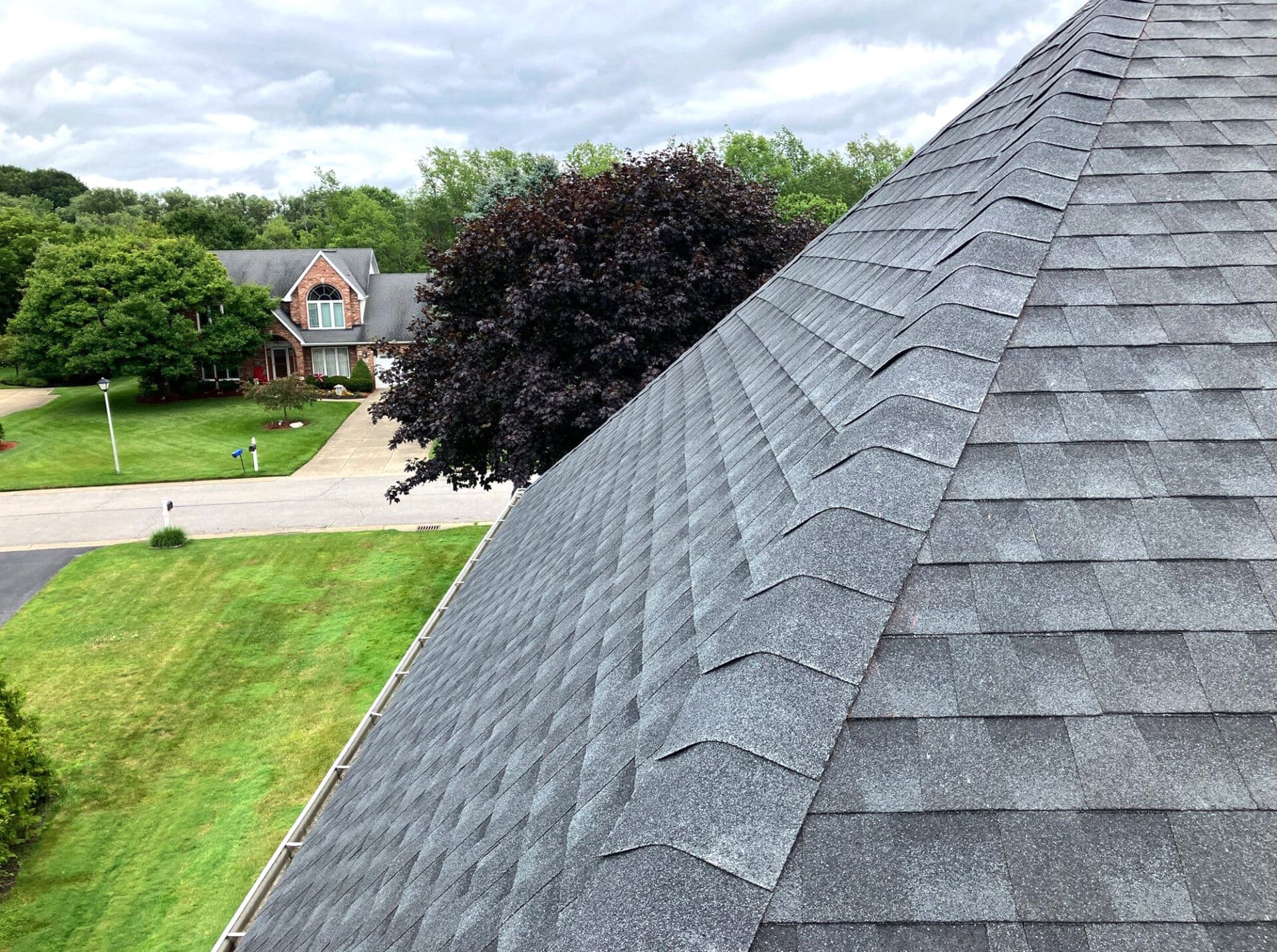 Gray roof shingles. Residential neighborhood background.