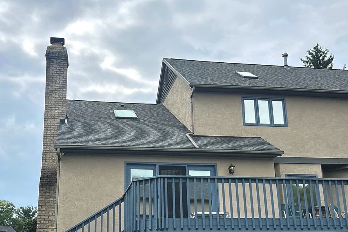 A house with a grey roof and blue trim