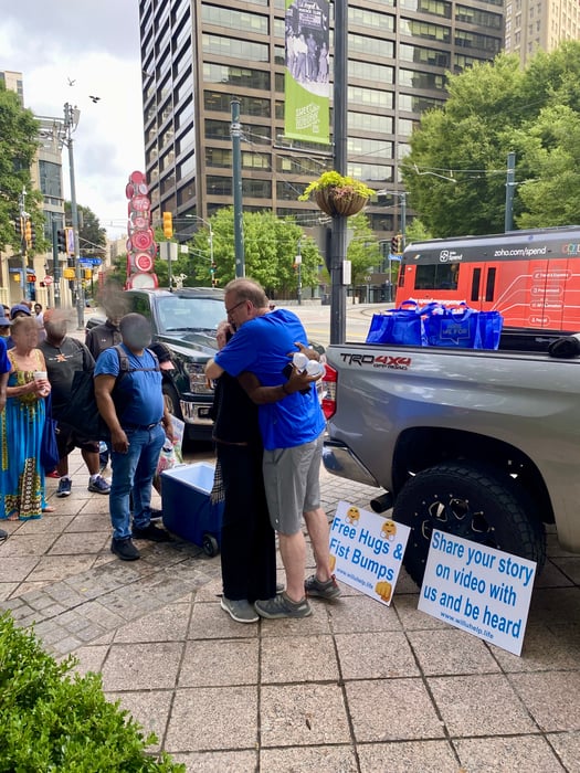Volunteer Lined Up to Hug and Love