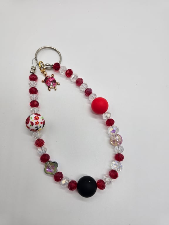 Red and Clear Beaded Phone Wristlet with Black Focal Bead and Silver Charm — photo 2