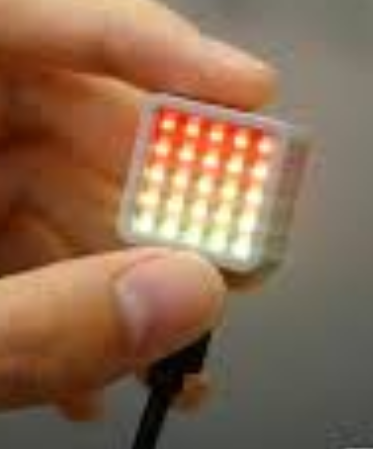 Atom Matrix held in hand, 5x5 LED grid showing the goal number in red