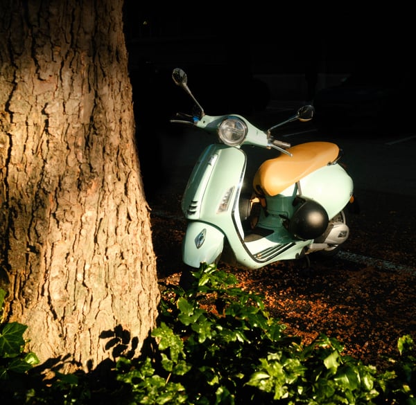 Blue Vespa. Bernoullistrasse, Basel, Switzerland, 7:13 PM, Monday, 13 May 2024. Fujifilm X100VI, flash off, f/4.5 at 1/320 at Auto ISO 250. Reggie's Portra + Glimmerglass + Luminar Neo.