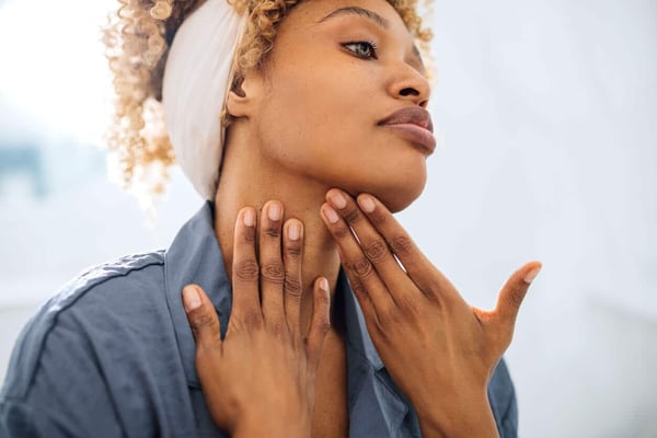 How to Prevent and Correct Wrinkles on Neck. Pretty Woman Applying Face Cream on her Neck stock photo