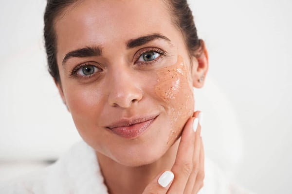 Our Total Body Guide to Skin Exfoliation. Woman touch face and enjoying of her skin stock photo