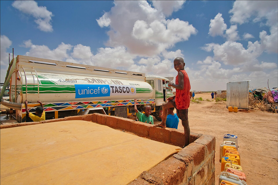 In Somalia erwarten Kinder die Ankunft eines Tanklastwagens mit sauberem Trinkwasser.